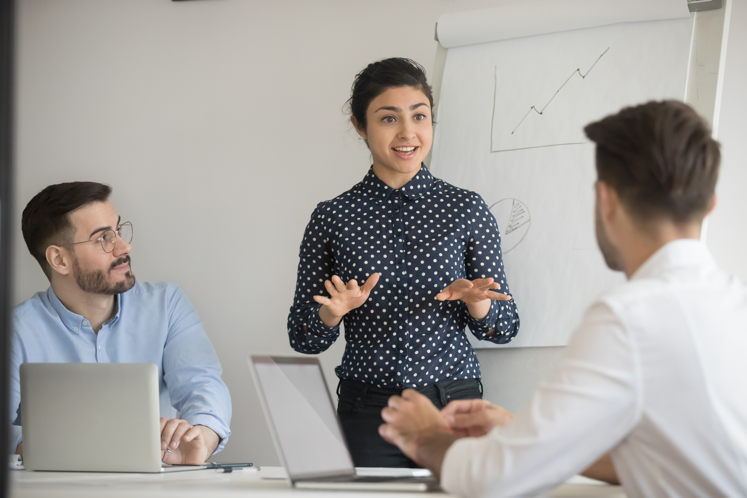 Indian confident business trainer giving presentation to corporate staff